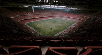Movie still from “28 Weeks Later” (2007), directed by Juan Carlos Fresnadillo – An empty soccer stadium with no fans during a soccer game; Extreme Wide shot, High angle