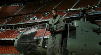 Movie still from “28 Weeks Later” (2007), directed by Juan Carlos Fresnadillo – A man standing next to an open door of a helicopter; Medium shot, Low angle