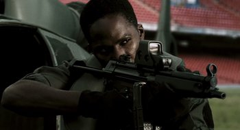 Movie still from “28 Weeks Later” (2007), directed by Juan Carlos Fresnadillo – A man is holding a rifle and aiming it; Close Up shot, Low angle