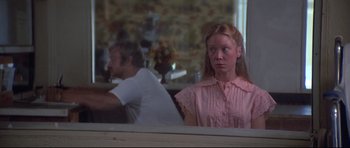 Movie still from “3 Women” (1977), directed by Robert Altman – A young woman in a pink shirt is looking at a man in a pink shirt; Medium shot, Over the shoulder angle
