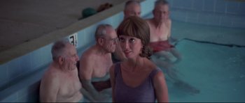 Movie still from “3 Women” (1977), directed by Robert Altman – A group of people in a pool of water with a woman; Medium shot, Over the shoulder angle