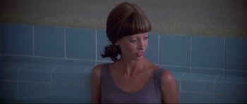 Movie still from “3 Women” (1977), directed by Robert Altman – A woman in a purple shirt is looking at the camera; Close Up shot, Low angle