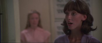 Movie still from “3 Women” (1977), directed by Robert Altman – Two women are standing in a room and one of them is looking at the camera; Close Up shot, Over the shoulder angle