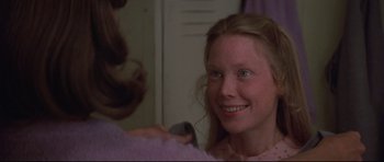 Movie still from “3 Women” (1977), directed by Robert Altman – A girl is smiling while a woman is cutting her hair; Close Up shot, Over the shoulder angle