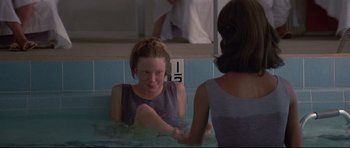 Movie still from “3 Women” (1977), directed by Robert Altman – A woman sitting in a pool of water next to another woman; Medium shot, Over the shoulder angle