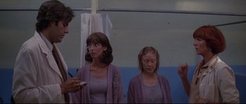 Movie still from “3 Women” (1977), directed by Robert Altman – Two women standing in front of each other in front of a curtain; Medium shot, Low angle