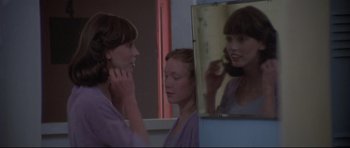 Movie still from “3 Women” (1977), directed by Robert Altman – A woman looking in the mirror while another woman looks on; Close Up shot, Over the shoulder angle