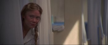 Movie still from “3 Women” (1977), directed by Robert Altman – A woman standing next to a window looking at the camera; Close Up shot, Over the shoulder angle