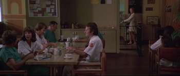 Movie still from “3 Women” (1977), directed by Robert Altman – A group of people sitting at a table eating food; Wide shot, Over the shoulder angle