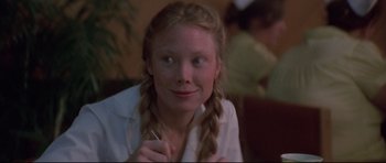Movie still from “3 Women” (1977), directed by Robert Altman – A girl with plaited pigtails sitting in a room; Close Up shot, Over the shoulder angle