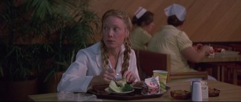 Movie still from “3 Women” (1977), directed by Robert Altman – A woman sitting in front of a plate of food; Medium shot, Over the shoulder angle