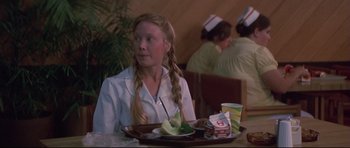 Movie still from “3 Women” (1977), directed by Robert Altman – A woman sitting in front of a plate of food; Medium shot, Over the shoulder angle