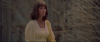 Movie still from “3 Women” (1977), directed by Robert Altman – A woman in a yellow dress standing in front of a tree; Close Up shot, Low angle