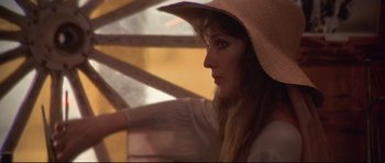 Movie still from “3 Women” (1977), directed by Robert Altman – A woman wearing a straw hat looking out of a window; Close Up shot, Low angle