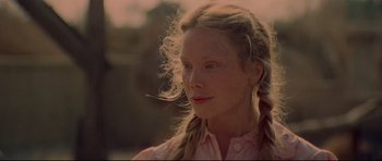 Movie still from “3 Women” (1977), directed by Robert Altman – A woman with long blonde plaits looking to her left; Close Up shot, Low angle