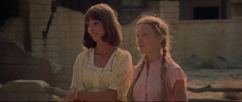 Movie still from “3 Women” (1977), directed by Robert Altman – Two young women standing next to each other; Medium shot, Low angle