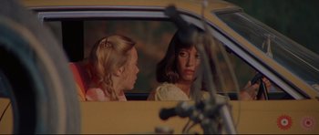 Movie still from “3 Women” (1977), directed by Robert Altman – Two young girls sitting in the drivers seat of a yellow car; Close Up shot, Over the shoulder angle