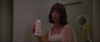Movie still from “3 Women” (1977), directed by Robert Altman – A woman holding a carton of milk in her hand; Close Up shot, Low angle
