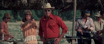 Movie still from “3 Women” (1977), directed by Robert Altman – A man in a red shirt wearing a cowboy hat; Medium shot, Low angle