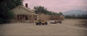 Movie still from “3 Women” (1977), directed by Robert Altman – An old jeep parked in front of an old house; Extreme Wide shot, High angle