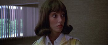 Movie still from “3 Women” (1977), directed by Robert Altman – A person wearing a yellow and white shirt; Close Up shot, Low angle