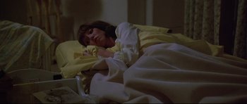 Movie still from “3 Women” (1977), directed by Robert Altman – A woman laying in a bed under a yellow blanket; Medium shot, High angle