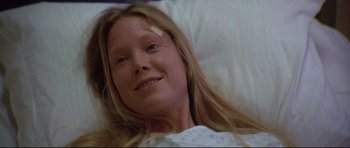 Movie still from “3 Women” (1977), directed by Robert Altman – A young woman laying in a bed with a bandage on her head; Close Up shot, High angle