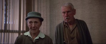 Movie still from “3 Women” (1977), directed by Robert Altman – An older man standing next to an older woman; Close Up shot, Low angle