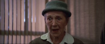 Movie still from “3 Women” (1977), directed by Robert Altman – An old woman with a hat and a surprised look; Close Up shot, Over the shoulder angle