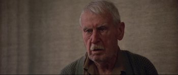 Movie still from “3 Women” (1977), directed by Robert Altman – An old man with a gray beard stares at the camera; Close Up shot, Low angle