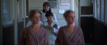 Movie still from “3 Women” (1977), directed by Robert Altman – A group of women standing next to each other in a room; Medium shot, Over the shoulder angle