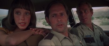 Movie still from “3 Women” (1977), directed by Robert Altman – A man in the back of a car holding a woman in the back of a car; Close Up shot, Low angle