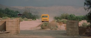 Movie still from “3 Women” (1977), directed by Robert Altman – A yellow truck driving down a dirt road near bushes; Extreme Wide shot, High angle