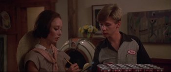 Movie still from “3 Women” (1977), directed by Robert Altman – A man and a woman sitting at a table with cans; Medium shot, Over the shoulder angle