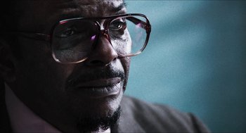Movie still from “3 from Hell” (2019), directed by Rob Zombie – A person wearing glasses; Close Up shot, Low angle