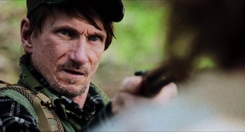 Movie still from “3 from Hell” (2019), directed by Rob Zombie – A person holding a cell phone; Close Up shot, Over the shoulder angle