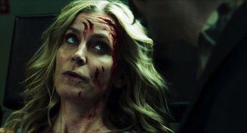 Movie still from “3 from Hell” (2019), directed by Rob Zombie – A person with blood all over her face; Close Up shot, Over the shoulder angle