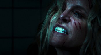 Movie still from “3 from Hell” (2019), directed by Rob Zombie – A person's face with blood on her face; Close Up shot, Overhead angle