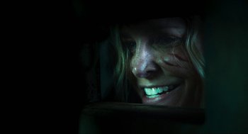 Movie still from “3 from Hell” (2019), directed by Rob Zombie – A person with a smile on their face; Close Up shot, Over the shoulder angle