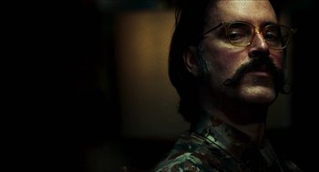 Movie still from “3 from Hell” (2019), directed by Rob Zombie – A person wearing glasses and a beard; Close Up shot, Low angle