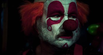 Movie still from “3 from Hell” (2019), directed by Rob Zombie – A person wearing a clown mask; Close Up shot, Low angle