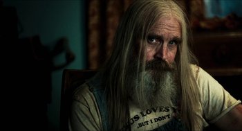 Movie still from “3 from Hell” (2019), directed by Rob Zombie – An old man with long white hair and a beard; Close Up shot, Over the shoulder angle