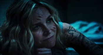 Movie still from “3 from Hell” (2019), directed by Rob Zombie – A person laying on the ground; Close Up shot, Over the shoulder angle