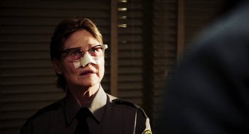 Movie still from “3 from Hell” (2019), directed by Rob Zombie – A police officer with a bandage on his face; Close Up shot, Over the shoulder angle