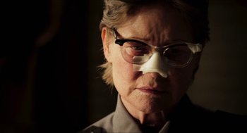 Movie still from “3 from Hell” (2019), directed by Rob Zombie – An older woman wearing glasses and a nose mask; Close Up shot, Low angle