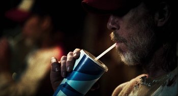 Movie still from “3 from Hell” (2019), directed by Rob Zombie – A person drinking from a cup; Close Up shot, Over the shoulder angle