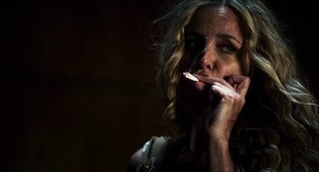 Movie still from “3 from Hell” (2019), directed by Rob Zombie – A person smoking a cigarette; Close Up shot, Low angle