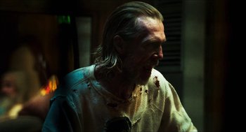 Movie still from “3 from Hell” (2019), directed by Rob Zombie – A person wearing a shirt with blood all over it; Close Up shot, Over the shoulder angle