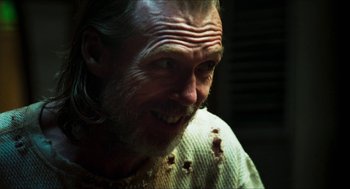 Movie still from “3 from Hell” (2019), directed by Rob Zombie – A person wearing a sweater; Close Up shot, Over the shoulder angle