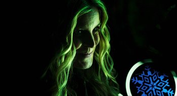 Movie still from “3 from Hell” (2019), directed by Rob Zombie – A woman with green hair is smiling for the camera; Close Up shot, Over the shoulder angle